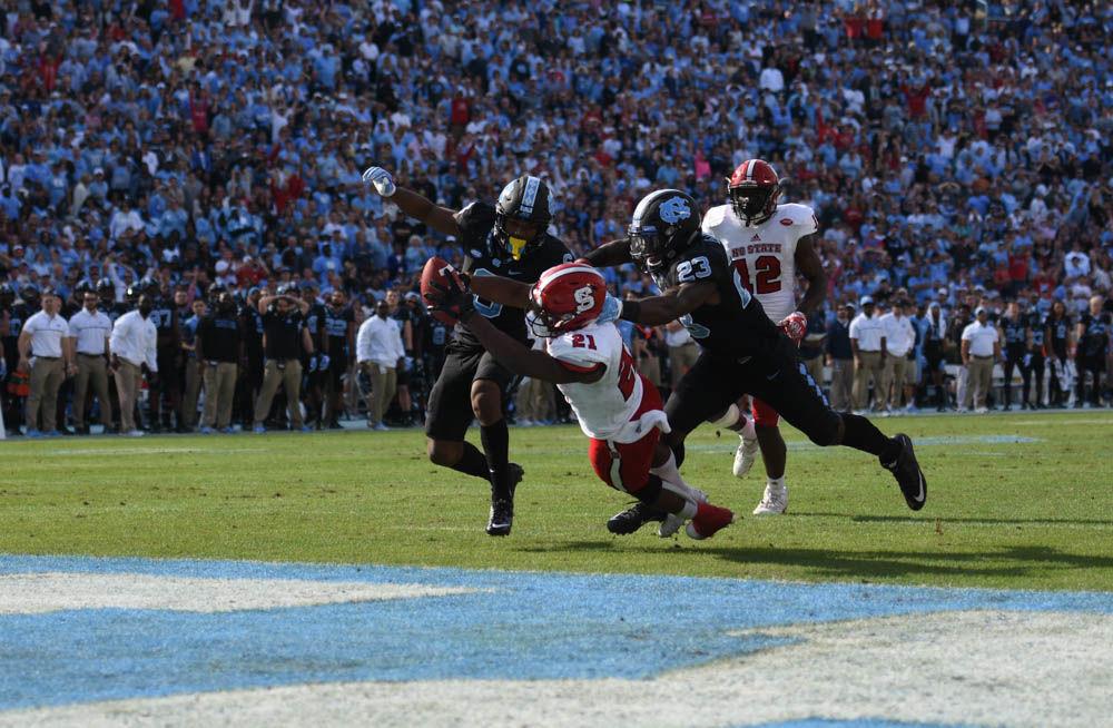 Senior running back Matt Dayes scores a touchdown in Kenan Stadium on Friday. Since the Wolfpack defeated the Tar Heels, 28-21, Dayes will play in a bowl game, which will be announced on Dec. 4.