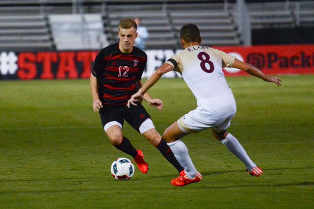 Freshman midfielder Jan-Juca Ahillen cuts to avoid an Elon player. The NC State men's soccer team lost to Elon 2-0 at Dail Soccer Stadium Sept. 13.