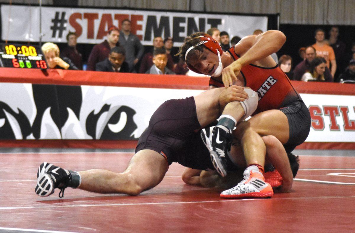 Max Rohskopf, junior 165-pounder, attempts to finish a single leg during his match against in conference opponent Virginia Tech. The No. 8 Hokies would go on to beat the Wolfpack by a score of 19-14 in the Holshouser Building Feb. 12.