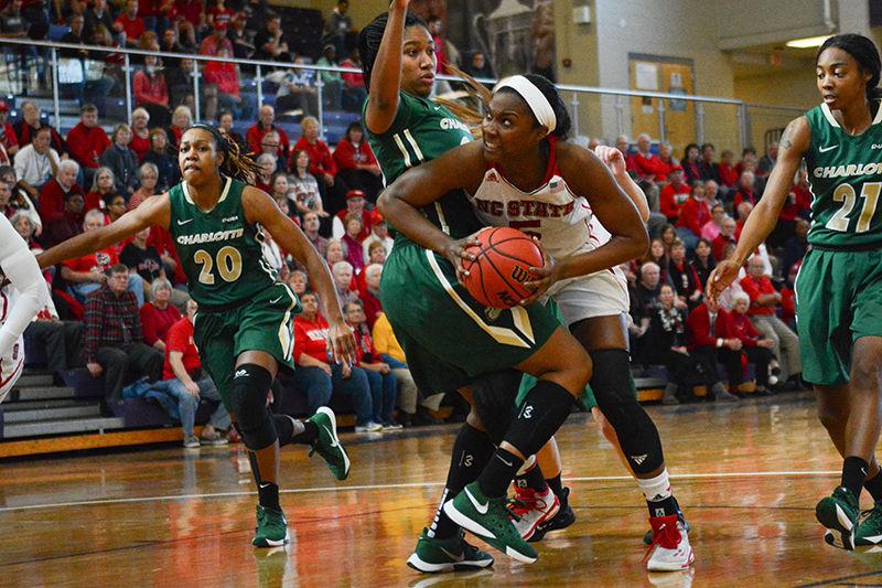 Sophomore forward Chelsea Nelson fights her way around a UNC-Charlotte defender to get to the basket in the Wolfpack women's basketball 72-65 win on Dec. 6.