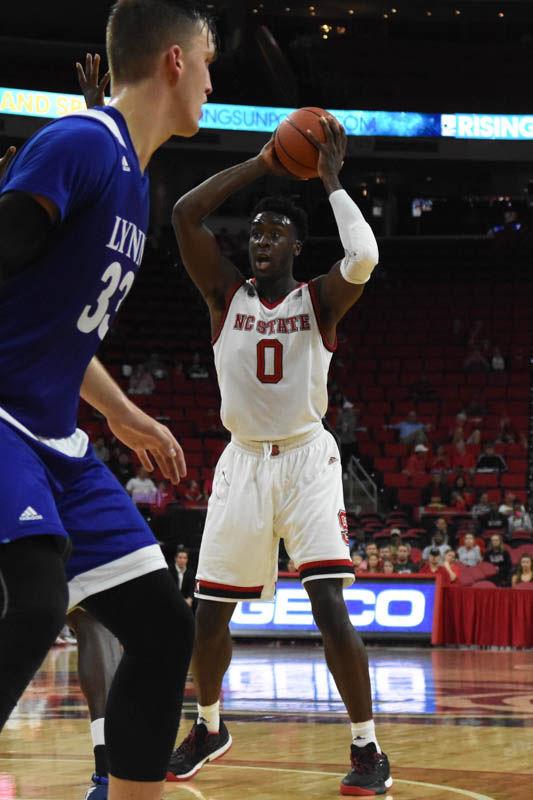 Junior forward Abdul-Malik Abu maneuvers the ball against Lynn University. Abu had four blocks in the game. The Wolfpack defeated Lynn University 100-66.