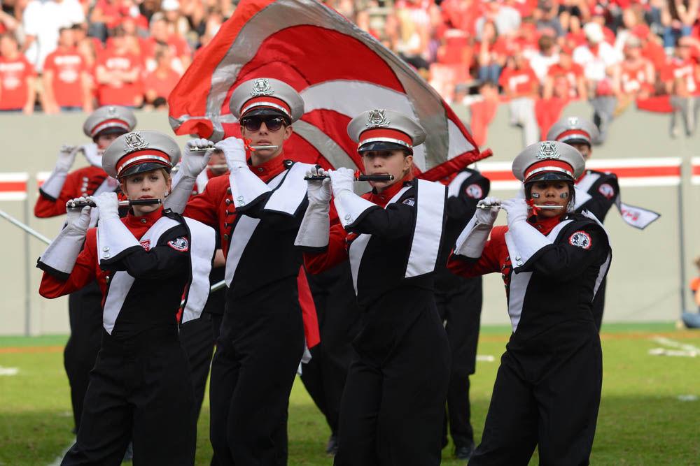 Members of the piccolo section of The Power Sound of The South perform during halftime on Saturday during the game at Carter-Finley Stadium against Miami. Senior members of the marching band were honored before their performance as apart of the Senior Day recognitions. The Wolfpack fell to Miami 27-13.