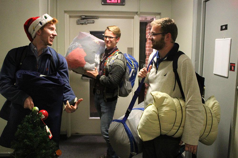 Joshua Connor, a senior studying materials science and engineering, and Haaken Lysne, a junior studying nuclear engineering, help Cullen Morgan, a freshman majoring in exploratory studies move back into Owen Hall after Thanksgiving break. When asked, they said they were stoked to be back.