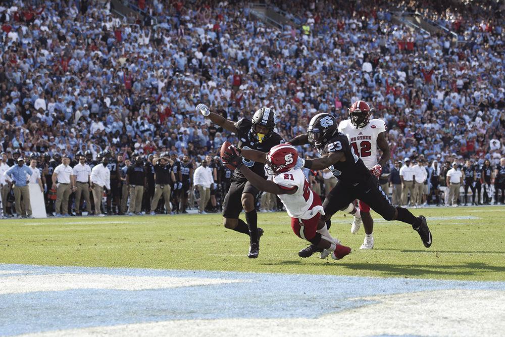 Senior running back Matt Dayes scores a touchdown in Kenan Stadium on Friday. Since the Wolfpack defeated the Tar Heels, 28-21, Dayes will play one last time in a bowl game, which will be announced on Dec. 4.