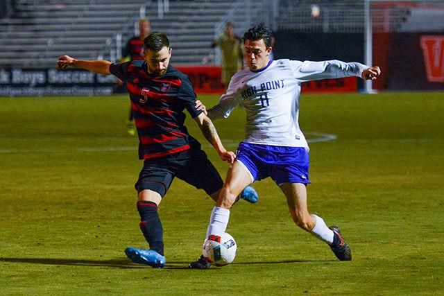 Senior midfielder Lukas Zarges is blocked before an attempted pass to center field. Zarges took two shots during the game, one of them on goal. The NC State men's soccer team lost to High Point University 4-3 in the first half of overtime on Oct. 11 at Dail Soccer Stadium.