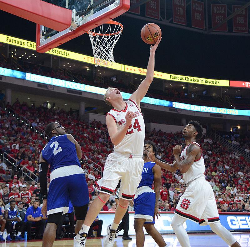 Sophomore Maverick Rowan struggles for two points against Lynn University. Rowan had a total of 17 points throughout the game making a good start to the season. The men's basketball team took their first win with a final score of 100-66 in PNC Arena on Thursday.