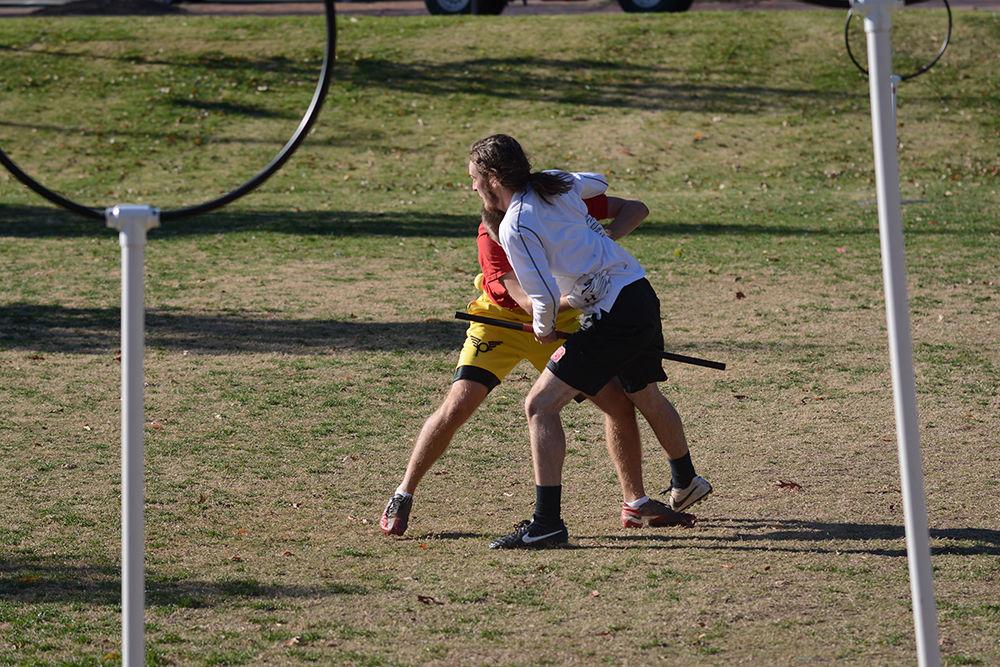 Seeker Michael Brown, a senior studying computer science and the captain of the Quidditch team, chases after the snitch Eric Fazekas, a senior studying chemical engineering, in Harris Field outside of Witherspoon Student Center on Sunday. They usually practice or play a game called Jack, which is a wizardly spin-off of the game dodgeball, on Monday, Wednesday, Friday and Sunday.