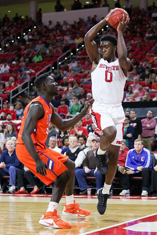 Then-sophomore forward Abdul-Malik Abu tries to throw the ball off of a Clemson player out of bounds to maintain possession of the ball. Abu had a monster game with 17 points, 16 rebounds, one assist and three blocks in 33 minutes. The NC State Wolfpack beat the Clemson Tigers in a close one, 77-74, at PNC Arena on Feb. 20.