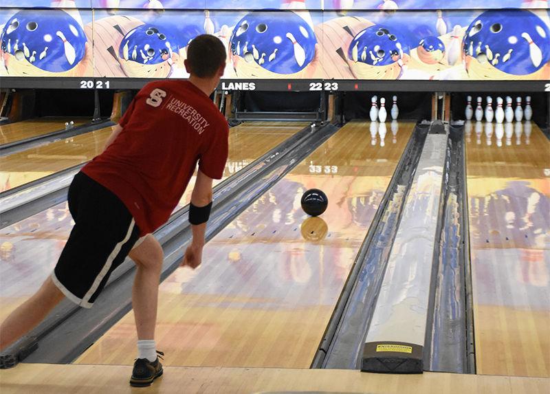 Tino Weiss, a senior studying computer science, aims to pick up the spare at the bowling club practice on Monday at Buffaloe Lanes North. The club meets three times per week, and is currently seeking new members.