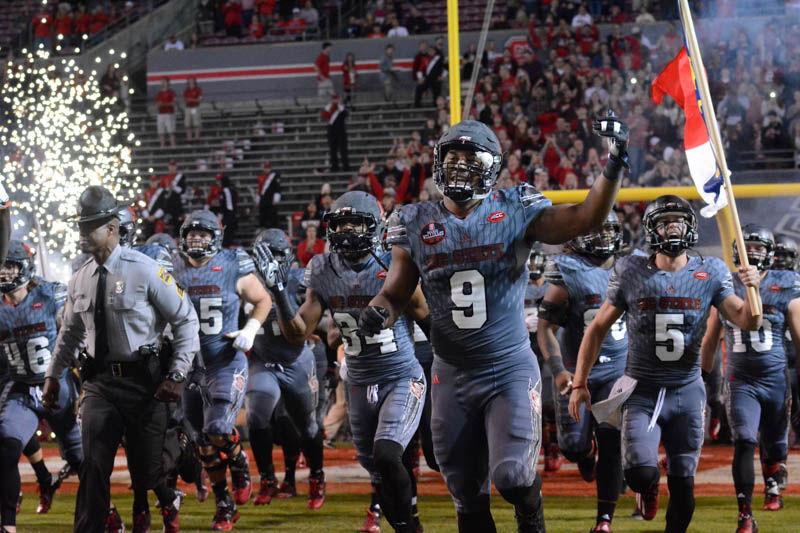 Bradley Chubb, a junior defensive end, runs out onto the field in Carter-Finley Stadium with his team. Chubb had two tackles during the game against Florida State. The Wolfpack lost the game by a score of 24-20 against the Seminoles.