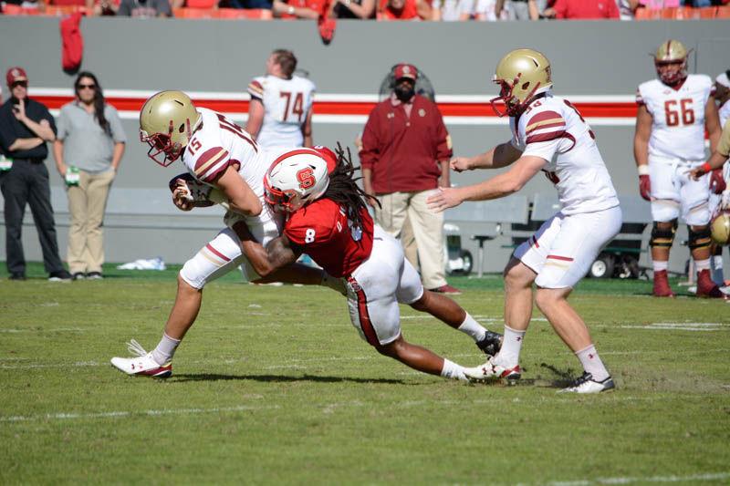 Senior defensive back Dravious Wright tackles sophomore wide receiver Troy Flutie during the homecoming game against Boston College in Carter-Finley Stadium on Saturday. Boston College won against the Wolfpack, 21-14.