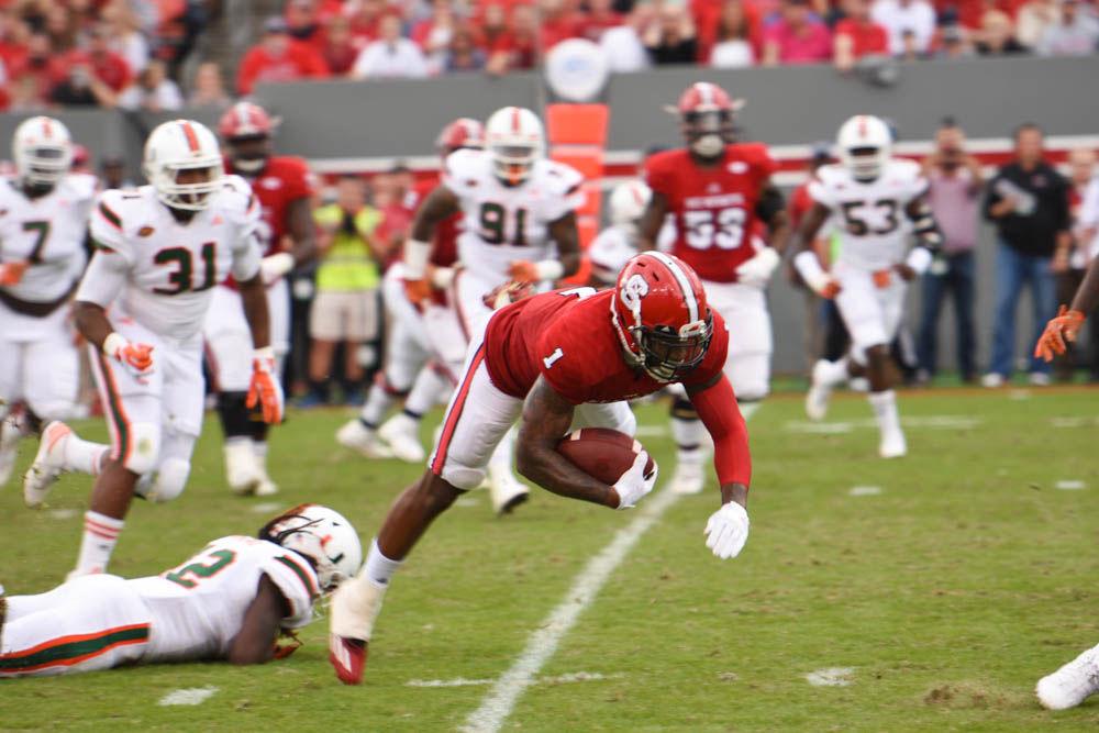 Junior tight end Jaylen Samuels fails to advance the ball for the Wolfpack on Saturday. Samuels gained 28 yards for the Pack. NC State fell to Miami, 27-13.