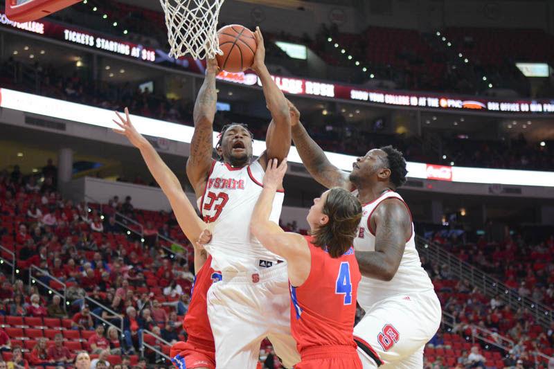 Freshman forward Ted Kapita and senior forward Beejay Anya go up for a steal from St. Francis players Gunnar Olaffson and Jagos Lasic. In his debue game, Kapita scored 17 points with 8 rebounds, and Anya added 7 points to NC State's 86-61 win in PNC Arena over Wofford College on Nov. 13, 2016.
