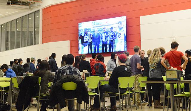 Students watch the coin toss of Super Bowl 50 in Talley Student Union. The Carolina Panthers [BEAT/LOST TO] the Denver Broncos [SCORE] in Levi's Stadium, in Santa Clara, California Sunday. Several Panthers and Broncos fans showed up in their football fan gear to support their teams.&#160;