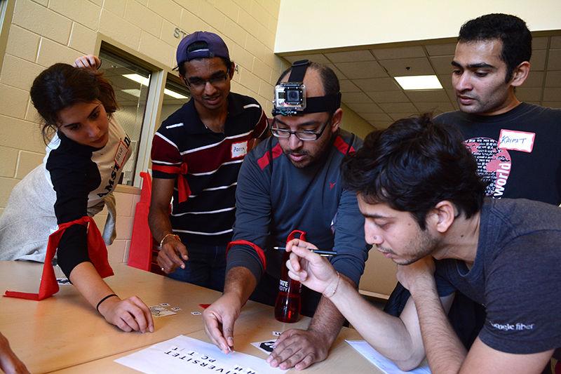 &#160;
Beliz Ilica, a freshman majoring in design studies from Turkey, Aditya Shirode, a graduate student studying computer science from India, Amr Helal, a fourth-year Ph.D. candidate studying civil engineering from Egypt, and Kalpit Mehta and Shashank Mathur, second-year graduate students studying electrical engineering from India, work together as a team. They put together the letters for the Russian word for university as part of the final challenge in the fifth annual Pangea Race, on the third floor of Witherspoon Student Center Friday. The team, which called themselves the "Global Pack" finished first place in the race for their course. There were eight challenges each team had to complete in order to receive clues for the next location on the course. Challenges included identifying international flags, playing a game of cricket and spray painting flags on the Free Expression Tunnel. The six teams consisted of mostly international students along with some American students. This was Helal's third Pangea race and the second one in which he was on the winning team. "I think it's a very good experience working as a team with different cultures and different personalities," Helal said. The Office of International Services sponsored the event.