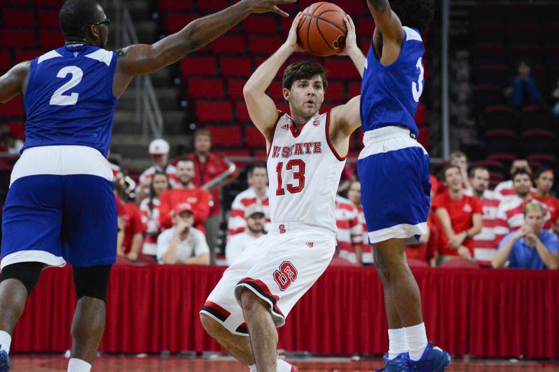 Junior guard Chris Corchiani Jr. manuevers between two players from Lynn University. Although he didn't have much playing time, Corchiani had several assists to his teammates and was able to score once. The Wolfpack team had their first win of the season in the exhibtion match on Thursday with a final score of 100-66.