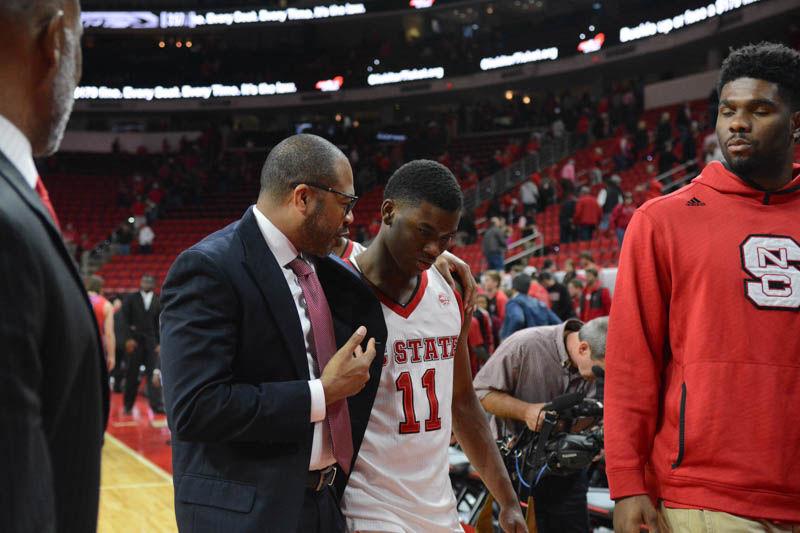 Assistand Head Coach Orlando Early speaks to freshman guard Markell Johnson following the Wolfpack's 86-61 win over the St. Francis Brooklyn College Terriers in PNC Arena on Nov. 13, 2016. Johnson scored six points and had three assists during his 21 minutes of gametime.