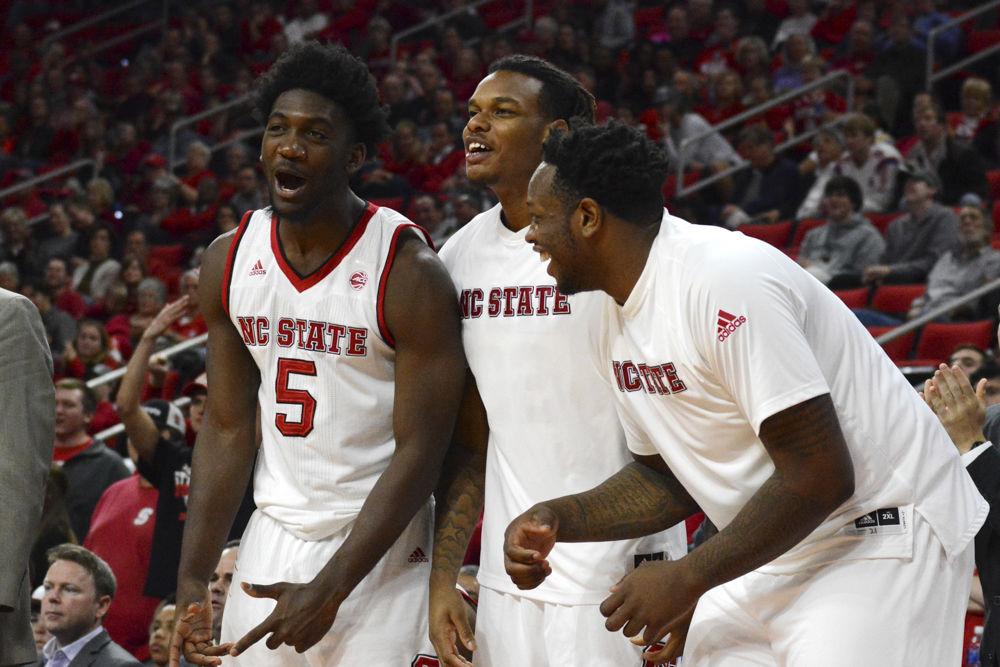 Darius Hicks, Shaun Kirk and Beejay Anya celebrate after a great play by their teammates. The Men's Basketball game won in their game versus Boston University with a final score of 77-73 in PNC Arena on Saturday.
