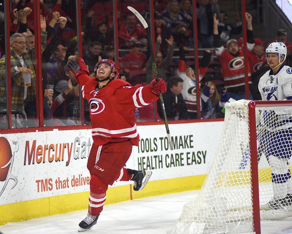 Hurricanes forward Phil Di Giuseppe celebrates after scoring the game-winning goal against Tampa Bay on Sunday in PNC Arena. Di Giuseppe tallied his first point of the season in the Hurricanes 1-0 overtime victory over the Lightning.
