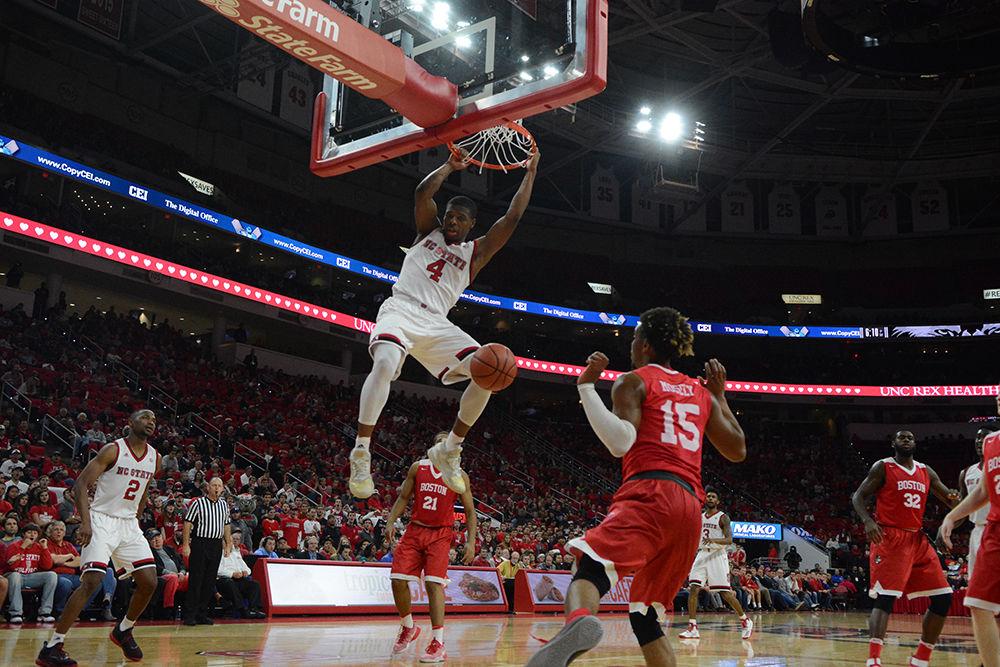 Freshman Dennis Smith Jr. swings from the rim after a dunk over Boston University. The freshman has had a great season so far and continued this with a total of 15 points and 3 assists during the game. The Men's Basketball team beat out BU with a final score of 77-73 at PNC Arena on Saturday.
