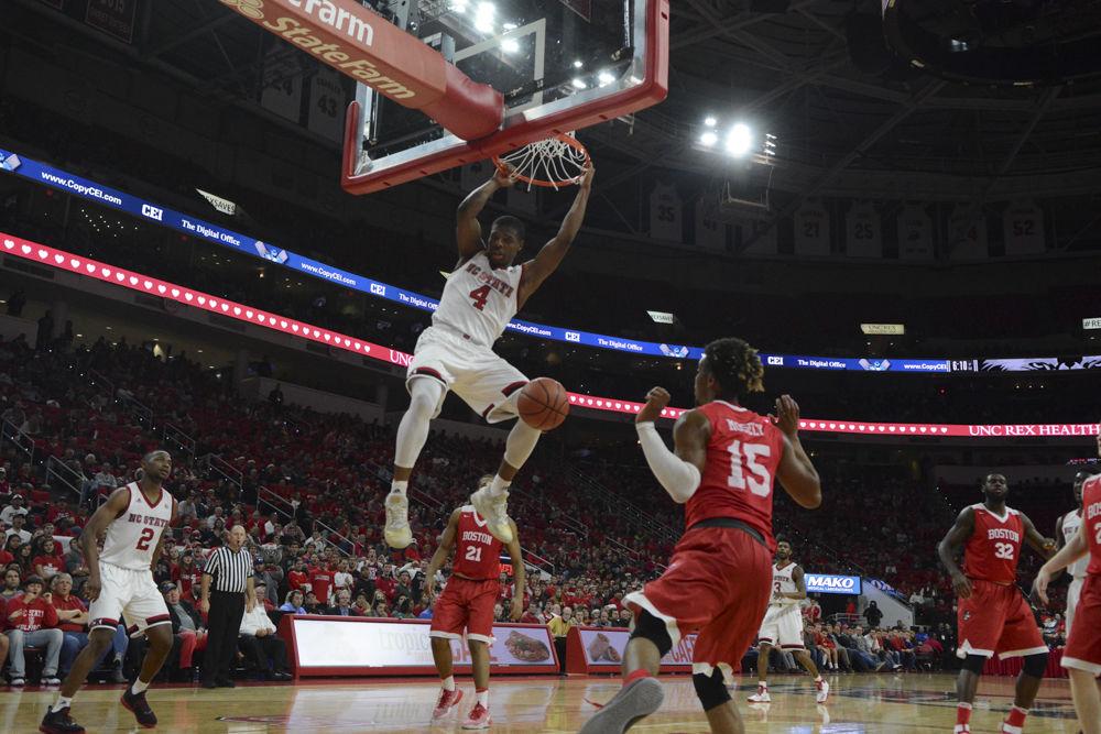 Freshman Dennis Smith Jr. swings from the rim after a dunk over Boston University. The freshman has had a great season so far and continued this with a total of 15 points and 3 assists during the game. The Men's Basketball team beat out BU with a final score of 77-73 at PNC Arena on Saturday.