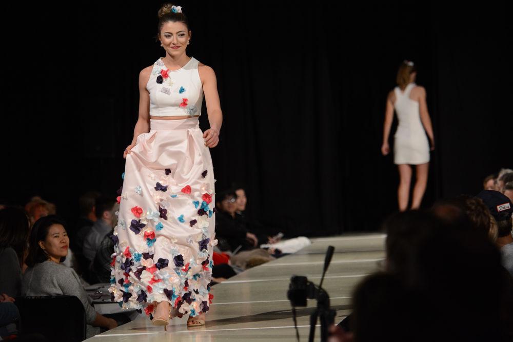 A model walks down the ramp in a LEDs incorporated garment from the Flourish collection by Allison Humphrey. The collection 'challenges the beliefs of the ideal women's body.' Allison mentioned that she drew inspiration from her own struggles with body image. She showcased her collection at the 206 Threads Senior Design Fashion Showcase that took place on December 3rd at the college of textiles.
