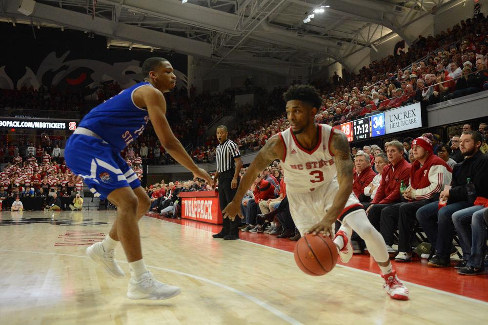 Red shirt Senior guard, Terry Henderson, dribbles the ball pass a Tennesse State player during the game at Reynolds Coliseum. Henderson lead the team with a total of 21 points throughout the game against TSU. The Wolfpack won the game on Saturday, December 10, 2016, with a score of 67-55.