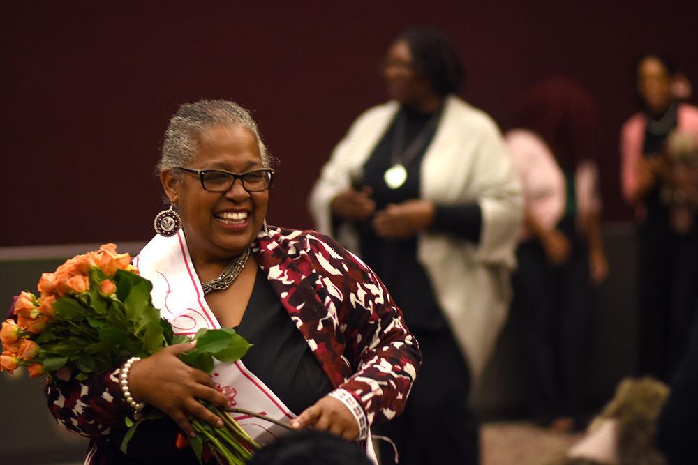 Toni "Mama" Thorpe is filled with joy after receiving flowers from her grandchildren at her retirement celebration held in the McKimmon Center on Monday. Students, colleagues and friends shared memories and gifts with Mama Thorpe to thank her for her years spent at NC State.