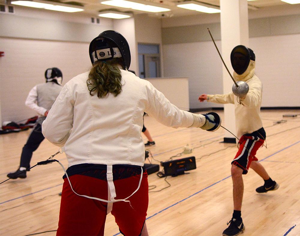 Genetta Young, junior studying chemistry, fences against Kyle Sozanski, a senior studying ecology, evolution and conservation biology, and also the Vice President of the Fencing Club on Wednesday. The members of the club practice their fencing skills in the Carmichael Gymnasium every week on Monday and Wednesday nights.