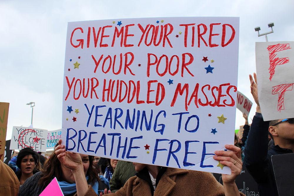 Protesters gathered outside Raleigh-Durham International Airport on Jan. 29, 2017 to show distain for a recent executive order signed by President Donald Trump that bans citizens of select countries from entering the U.S. A sign carried by one protestor reads "Give me your tiered,your poor, your huddled masses yearning to breath free" to show their support for the refugees that have been banned from entering the U.S.