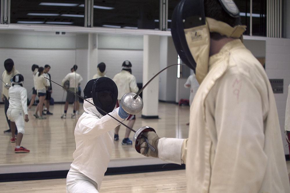 Members of the fencing club participate in warmups in the fencing room of Carmichael Gym on Wednesday. The Fencing Club meets Mondays and Wednesdays in Carmichael's fencing room from 7:30 p.m. to 10:30 p.m.&#160;