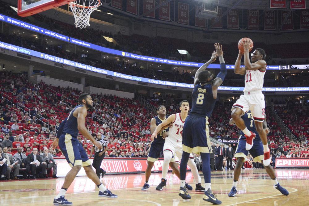 Freshman Markell Johnson goes for two points against players from Pittsburgh. Johnson contributed 8 points to the Wolfpack's total of 79 in the game versus Pittsburgh on Tuesday in PNC Arena.