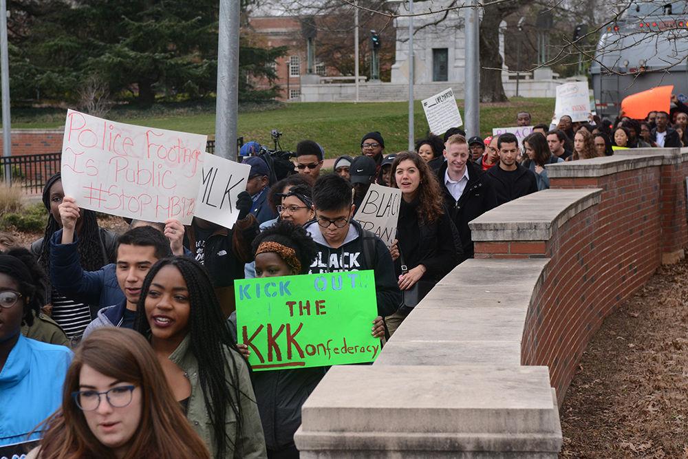 Activists hold their signs high as they make their way down Hillsborough Street during the ReclaimMLK March at Raleigh on Jan. 16, 2017. The march began at the NC State Belltower and followed Hillsborough Street to the North Carolina State Capitol building where individuals spoke about grievances and issues facing schools and communities in North Carolina and the nation.