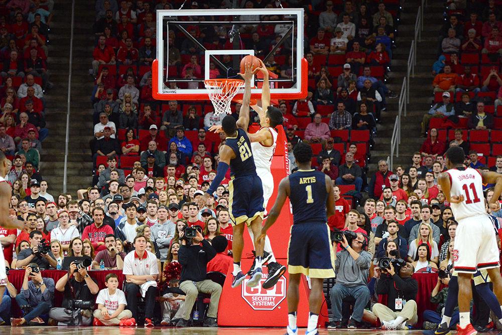 Freshman center Omer Yurtseven dunks on players from Pittsburgh. Yurtseven ended with a total of 12 points and 16 rebounds in the game versus Pittsburgh on Tuesday in PNC Arena.