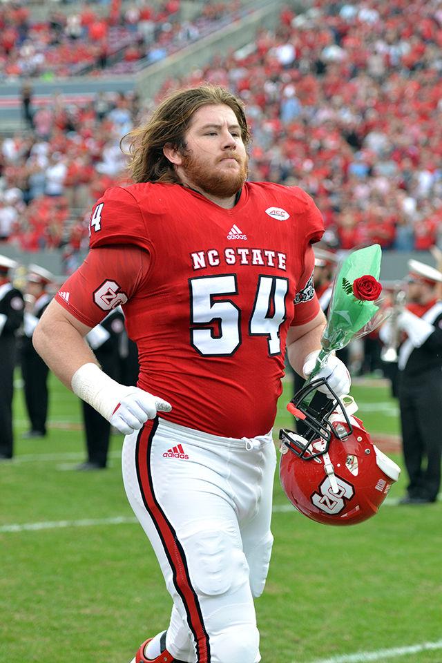 Graduate offensive guard Joe Thuney runs toward his coach and family as part of the NCSU Football team Senior Day celebrations before the game vs UNC Chapel Hill on Saturday, Nov. 28.
