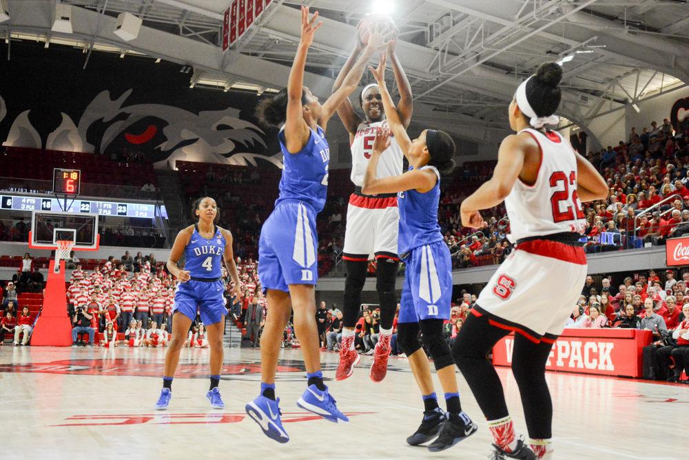 Junior forward Chelsea Nelson snatches the ball from above Duke defenders following an attempt by NC State for a basket. Nelson put 13 points on the board for the NCSU women's basketball team and had a team-high ten rebounds in 35 minutes of play against Duke on Jan. 15 in Reynold's Coliseum. The Wolfpack defeated the Blue Devils 55-52.