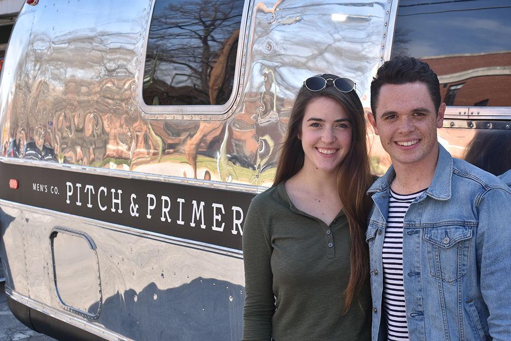Co-founders Lauren Stilwell, a senior studying fashion and textile design, and Jared Childs, an NC State alumnus, stand outside the mobile storefront for their men's clothing subscription service, Pitch and Primer.
