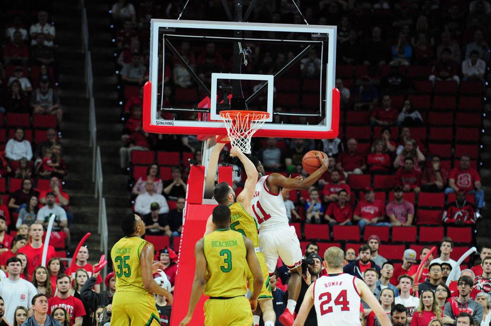 Wolfpack freshman, Markell Johnson, makes a reverse layup agianst Junior Matt Farrell of Notre Dame. Markell finished the game with 12 points and 5 assists in Saturday's contest.