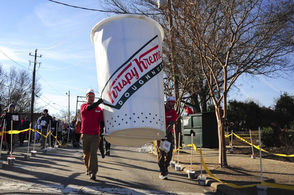 Tom Place and Everett Bradford from Durham and Apex, respectively, make the turn carrying their Krispy Kreme coffee cup during the Krispy Kreme Challenge on Feb. 4. The two spent three weeks on and off and an all nighter to create the cup. This year there were over 6900 participants registered in the race.
