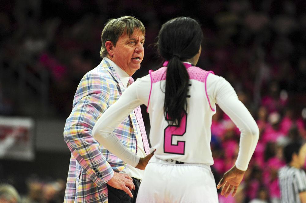 Head coach Wes Moore talks with redshirt freshman Kaila Ealey in the annual Play4Kay game at Reynolds Coliseum. NC State fell to Wake Forest 89-77 on Feb. 19.