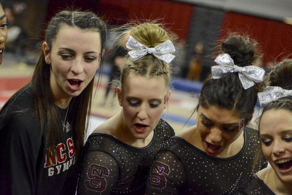 Members of the NC State gymnastics team gather together to celebrate in the quad meet agaisnt UNC-Chapel Hill, Pittsburgh, and William &amp; Mary in the Reynold Coliseum on Feb. 10, 2017. The meet ended with Wolfpack coming in second with a score of 195.025, behind UNC-Chapel Hill, 195.625 and ahead of Pittsburgh with 194.075 points.