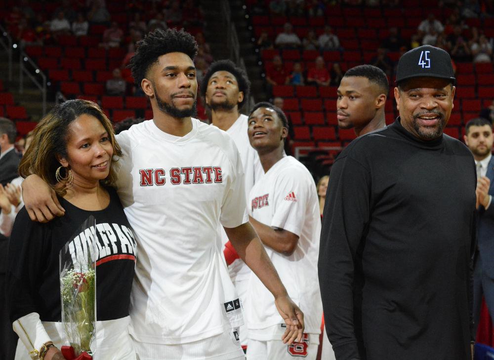 Redshirt Senior Terry Henderson walks out with family before being recognized at the men's basketball team last home game. Henderson has started every game this season and helped lead the pack as a powerful shooter throughout the 2016-2017 playing year.