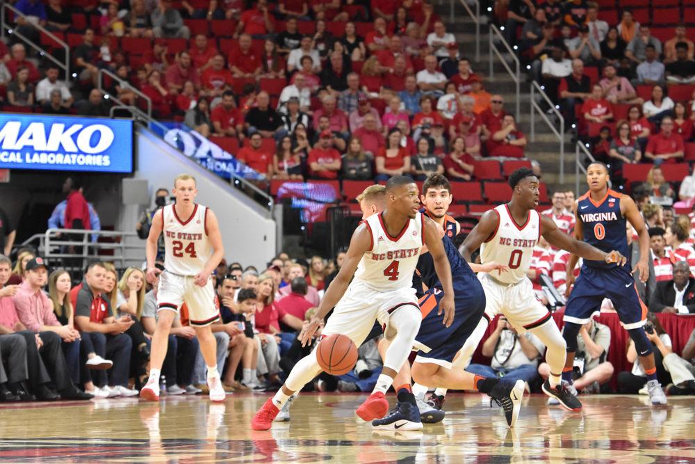 Freshman guard Dennis Smith Jr. weaves through the Virginia defense in PNC Arena on Feb. 25. Smith contributed 13 points to the Wolfpack total. NC State was defeated by Virginia with a score 70-55.