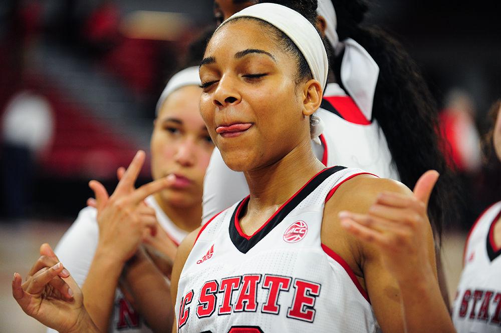 Senior guard Dominique Wilson enjoys the crowd as they give the seniors a standing ovation during the 4th quarter at Reynolds Coliseum. Wilson was one of four seniors who were honored at the game on Feb. 23, in which the Wolfpack took down UNC 80-60.