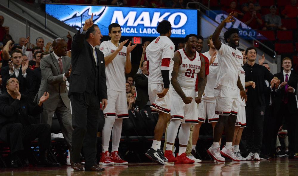 Members of the Men's Basketball team and coaching staff cheer for their team on the court. The energy was very much alive at the last home game in PNC Arena for the 2016-2017 Men's season. The Wolfpack had a good run against VCU but lost with a final score of 70-55 in PNC Arena on Saturday.