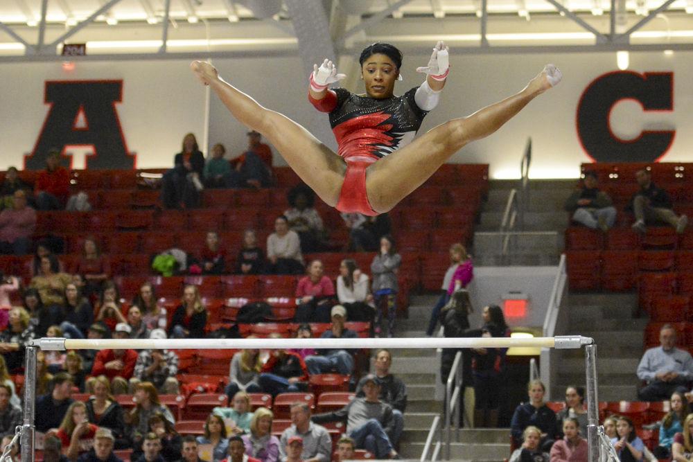 Junior gymnast Chelsea Knight focuses on the bar as she flies through the air in the Wolfpack's quad meet at Reynolds Coliseum on Feb. 10. The meet ended with Wolfpack coming in second with a score of 195.025, behind UNC-Chapel Hill with 195.625 points and ahead of Pittsburgh with 194.075 points.