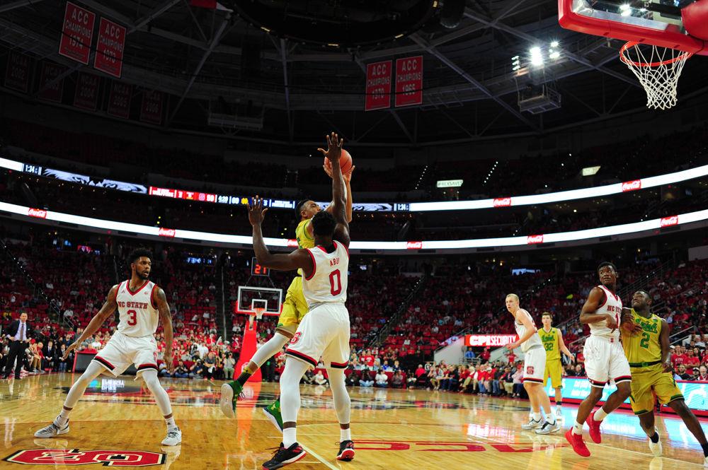 Junior Abdul-Malik Abu fouls Notre Dame's Bonzie Colson as the defensive end. The Wolfpack men's basketball team fell to the Figthting Irish on Saturday afternoon.