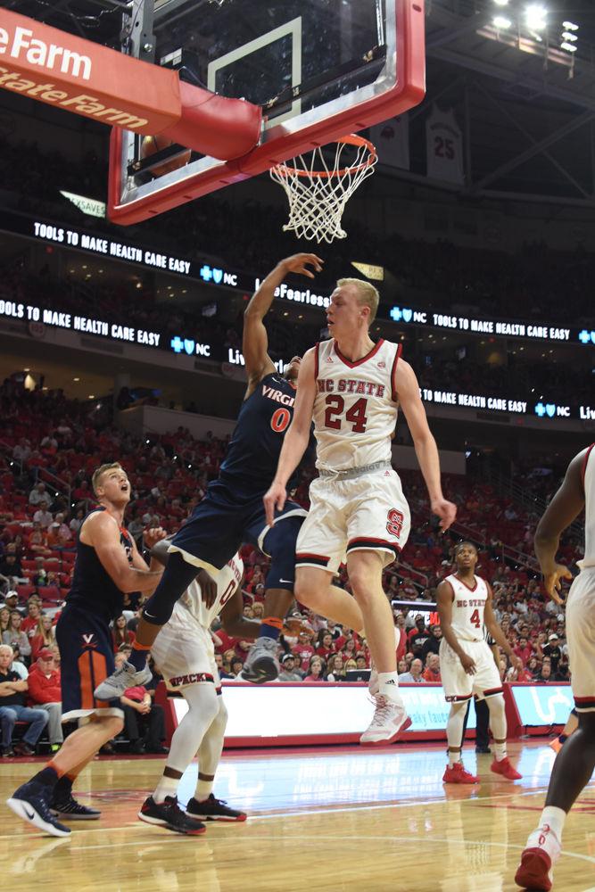 Maverick Rowan, a sophomore guard, blocks a lay up from Virginia player Devon Hall. Rowan had five defensive rebounds during the game on Feb. 25 in PNC Arena. The Pack was defeated 70-55.