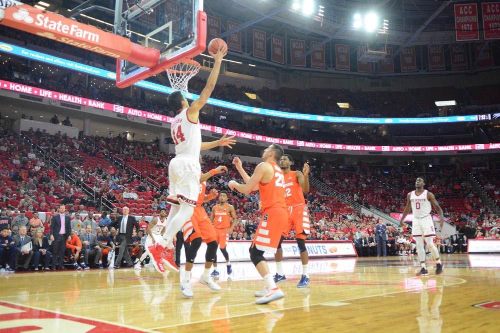 Omer Yurtseven goes up for two points against players from Syracuse. The Wolfpack lost in overtime with a final score of 100-93 in PNC Arena on Wednesday.