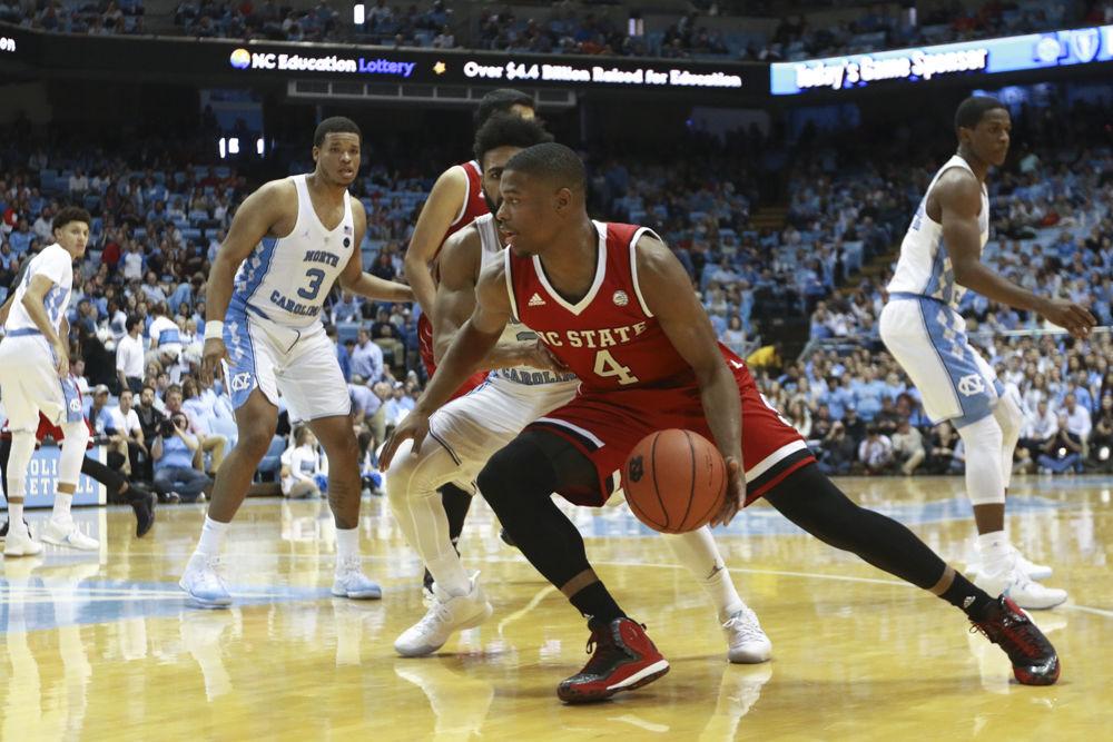 Freshman guard Dennis Smith Jr. drives down the baseline in the Wolfpack's 107-56 loss to UNC-CH on Jan 8. Smith Jr. shot 4 of 11 from the field with 11 points total in the loss at the Dean Smith Center.